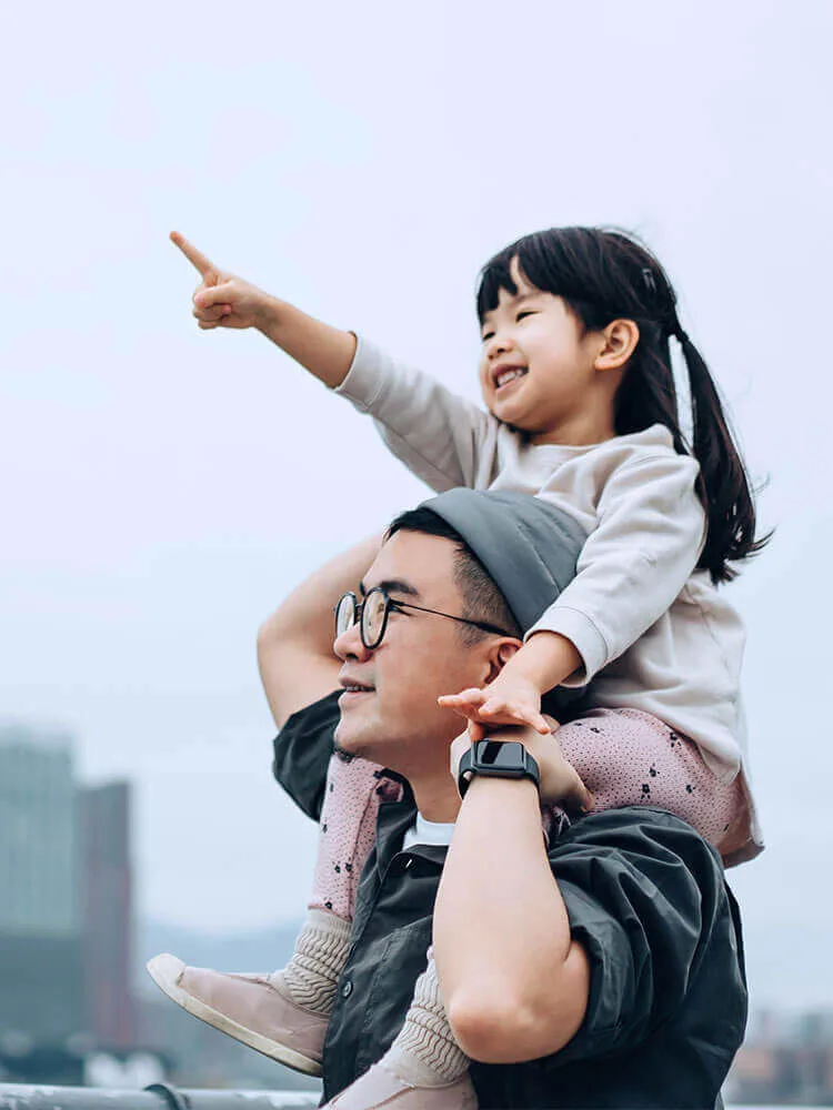 Asian father and daughter looking at the skyline