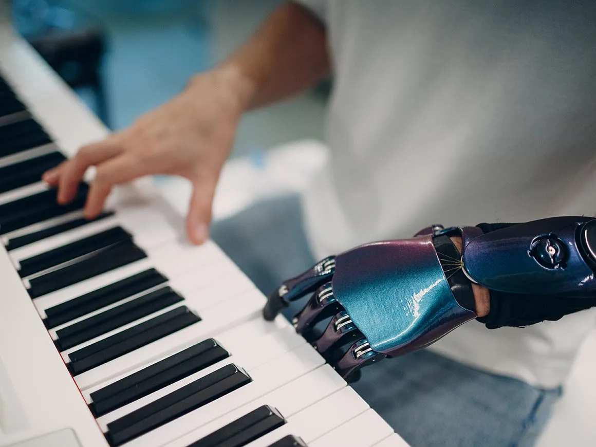 Man with prosthetic hand playing piano